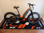 heybike-hero-ebike-side-view-on-orange-launchmat-floor-mat-block-design